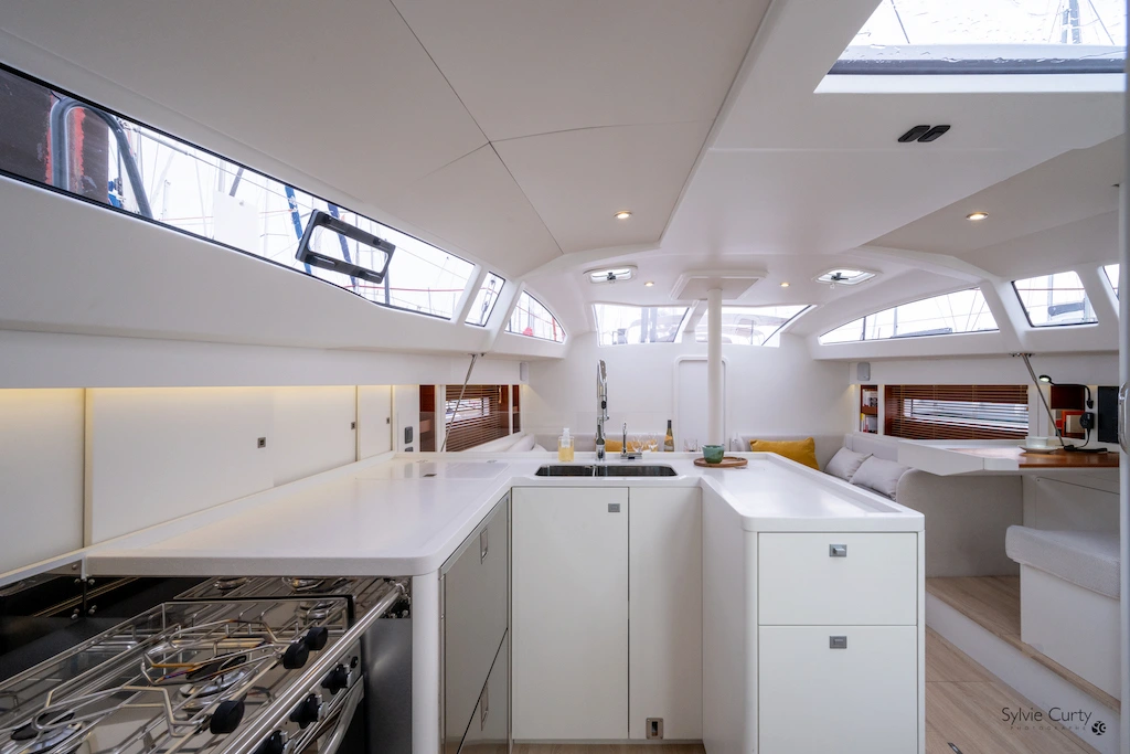 Hybrid RM 1380 interior galley and saloon with open layout, natural light, and an efficient space designed for long-distance cruising
