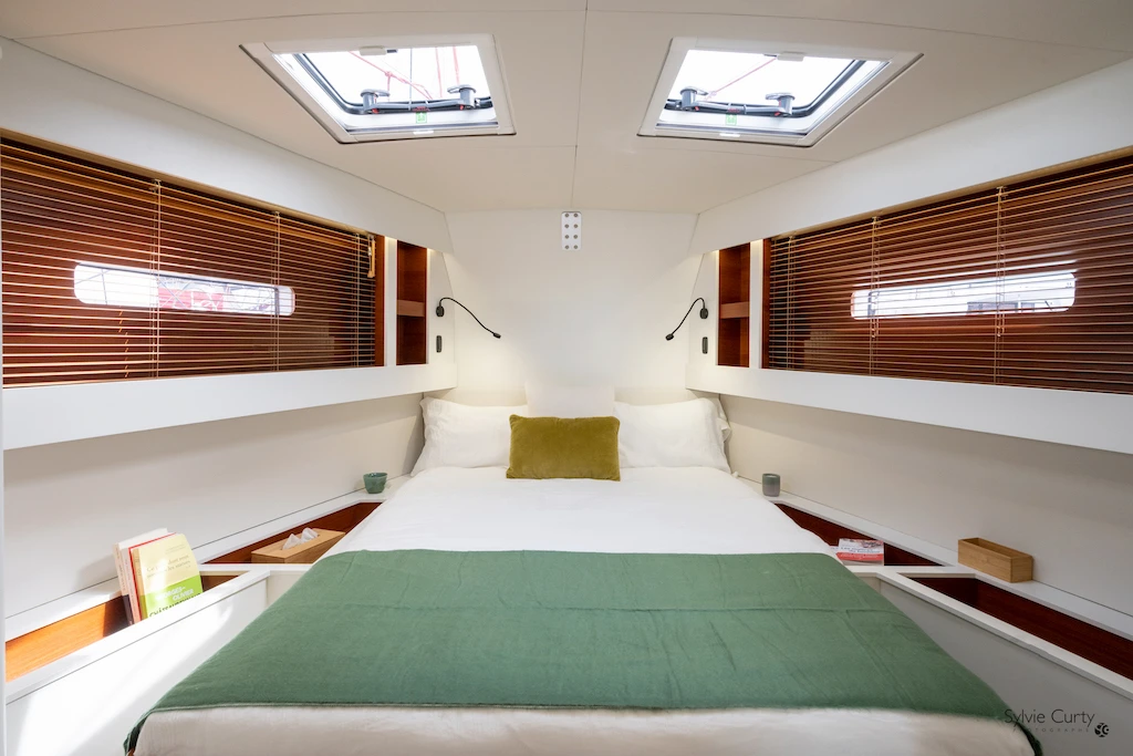 Hybrid RM 1380 owner cabin with generous berth, natural light, and a calm interior atmosphere suited to extended offshore cruising